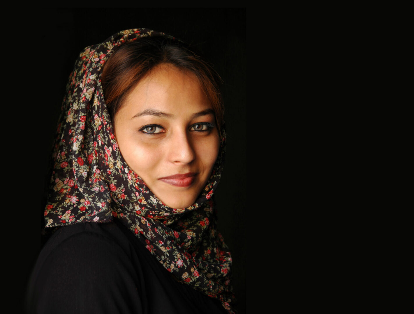 colored headshot photograph of woman in floral hijab