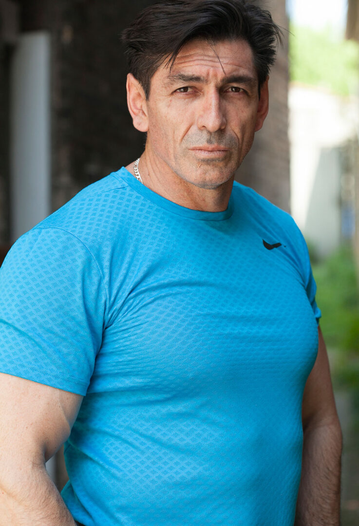 colored half-body photograph of man in athleisure and silver chains